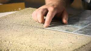 This type of tile is not ceramic and therefore not very hard, it is actually flexible and bends in your hand. How To Lay Stick Down Vinyl Tiles On Concrete Floors Flooring Help Youtube