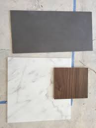 If you want your backsplash or bathroom marble to stand out then bright white is a great way to do it. Grey Tile Floor Carrera Marble Counters And Walnut Wood Cabinets Yay We Decided Faux Wood Tiles Gray Wood Tile Flooring Grey Floor Tiles