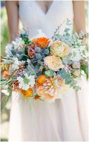 Australian native flowers are the trendiest blooms of 2019. Bridal Bouquet Cafe Au Lait Dahlias Orange Ranunculus Blue Thistle Summer Wedding Flowers Orange Wedding Flowers Bridal Bouquet Blue Wedding Flowers Summer