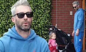 Adam Levine helps daughter Dusty Rose select a Christmas book to read as  they enjoy a stroll in LA