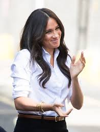 meghan markle looks polished in a classic white button down and trousers from her new clothing line haare