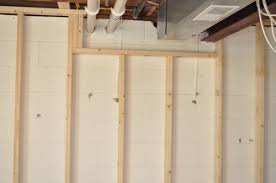 The framing step of a basement finishing project includes measuring and setting up wood frames and wall studs to outline the walls and openings of any room or rooms you add to your basement. Finishing A Basement Day 1 Framing The Walls