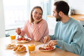 Portrait Of Young Happy Couple Eating Together While Having Breakfast Eat Eat Together Breakfast