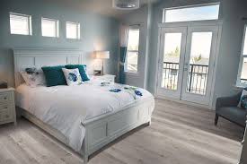 Another Way To Enhance The Natural Light And Create A Beachside Bedroom Is To Alter Your Color Palette Light Laminate Flooring Grey Flooring Bedroom Flooring