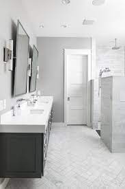 Chrome hardware gives this shower a classic elegant look, while glass walls add a modern touch. Grey Color Palette Ideas Master Bath White Marble Bathrooms Herringbone Tile Bathroom White Quartz Bathroom