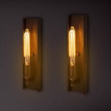 Once used to hold candles and torches against the wall to light the way, sconces remain a very popular choice in lighting, although are available in a much wider range of practical styles and designs. Bed Light Lamp Wall Lamp Wall Lights Wall Lamps Diy