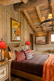 This cozy bedroom displays log cabin chic with wood panelling on the walls and ceilings. Western Bedroom Houzz