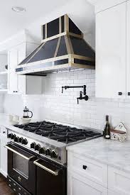 This kitchen pairs distressed wood open shelving with matching cabinets for a classic farmhouse feel. 12 White Kitchen Cabinets Black Hinges And Hardware Ideas White Kitchen Cabinets White Kitchen Kitchen Remodel