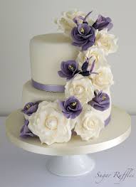 Couple a gorgeous traditional gown with some cowboy boots, and feel perfectly comfortable draping a denim jacket when the reception kicks into high gear. Purple Floral Cascade Wedding Cake Purple Wedding Cakes Flower Cake Wedding Cakes With Flowers