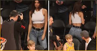 Wearing matching bathing suits, the photo featured ratajkowski stoically staring into the camera while she hugged her baby close with one arm. Basketball Fan Gets Caught By His Son While Checking Out Emily Ratajkowski