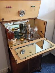 Tall liquor cabinet constructed from wood and finished with a mystic black pallet. 1940s Vintage Cocktail Cabinet Home Bar Cabinet Bar Cabinet Cocktail Cabinet