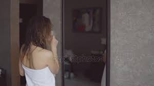 As i am dancing around my tiny bathroom, in my short shorts i stop for just a fraction of a moment to look in the mirror i see my reflection staring right back at me i look closer. Pretty Girl Sings And Dancing In Front Of The Mirror After Taking Shower Standing In Towel Video By C Lenblr Stock Footage 175336802