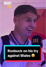 Tom Roebuck reacts to scoring a try against Wales
