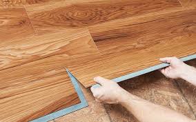 Two Hands Install A Grip Strip Vinyl Plank Over A Plywood Subfloor Vinyl Plank Flooring Installing Vinyl Plank Flooring Plank Flooring