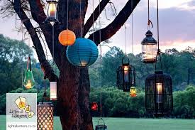 Various Paper Lanterns And Candle Lanterns Used As Decor For An Outside Function Decor Outside Event Candle Lanterns Storm Lantern Lanterns
