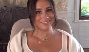 Meghan Markle poses with piles of her book as Duchess shares birthday  message