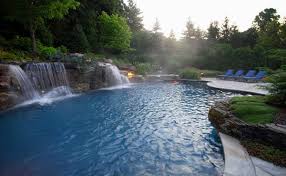 The waterfalls flowing from the rock formation offers serenity to the place. 15 Pool Waterfalls Ideas For Your Outdoor Space Home Design Lover