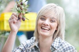 Woman holding olives in olive grove