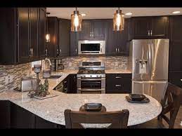 Match white, cape cod cabinets with a ceramic tile countertop to complement simplistic cottage decor. Espresso Kitchen Cabinets With Granite Youtube