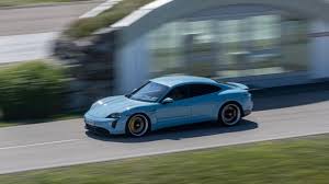 A nondescript white van rolls up beside my blue 2020 porsche taycan turbo as i sit at a red light on the pacific coast highway near huntington beach, calif. Porsche Achieves Robust Level Of Deliveries In 2020