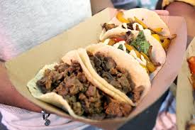 Two corn tortillas wrapped around a fried halibut fillet that's topped with cabbage. Taco Del Mar Near Me