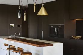Along with popular wood cabinets, many people today want white cabinets and walls with just a touch of color. Kitchens With Black Cabinets