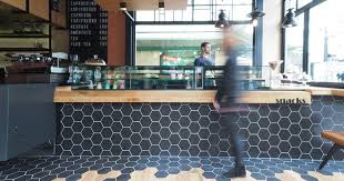 Hexagon Tiles Transition Into Wood Flooring Inside This Cafe In Greece Hexagon Tiles Cafe Interior Design