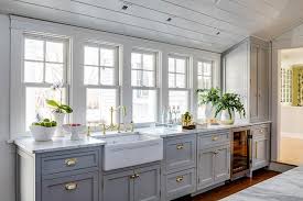 Barn wood is wrapped around the vent hood and ties in with the various other wood elements. Freshen Up A Farmhouse Kitchen With Shaker Cabinets Best Online Cabinets