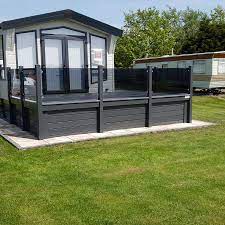 Achieve a clean and modern looking deck with out glass deck panels. Decking With Tinted Toughened Glass Panels Decking Supply Install Call 01745 827775
