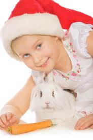 Cariñosa Chica Acariciando a Su Conejo En La Cama Foto de archivo