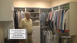 The closet includes white gloss doors & drawers with satin brass hardware, lighting, mirrored door fronts, clear glass doors to display hand bags & more! Custom Closets Marietta Ga Home Office Storage Solutions