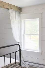 A soaring space comes down to earth with trimwork known as box beams. Farmhouse Window Trim Love Grows Wild