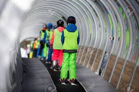 You must again control the ball in order not to fall. Rear View Of Children In Ski School Lifting The Slope With Conveyor Stock Photo Picture And Royalty Free Image Image 140519241