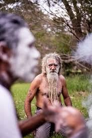 Image of Aboriginal man with clay face paint standing