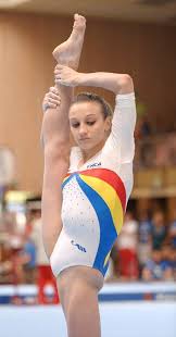 Competitive girls gymnastics is organized into levels. Gymnast In Action Gymnastics Poses Gymnastics Photography Female Gymnast