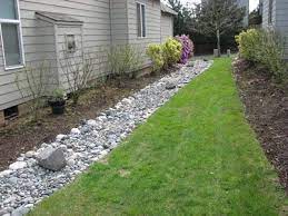I can tell that the french drain is working because water keeps draining out of the yard long after the rain has stopped. French Drain For Good Drainage Away From Barn Backyard Drainage Yard Drainage French Drain