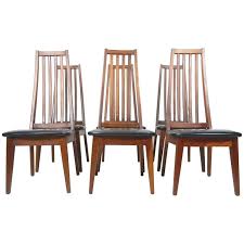 This single dining chair features a wood frame, a rich walnut or natural finish, and a handsome faux leather seat to ensure durability and comfort. Mid Century Danish Modern Tall Teak Wood Spindle Back Dining Chairs For Sale At 1stdibs
