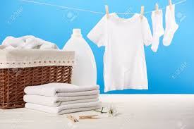 Of course, clothes are all sorts of different colors, so it is generally recommended to separate clothing by color, especially light and dark clothing. Laundry Basket Plastic Container With Laundry Liquid Pile Of Clean Soft Towels And White Clothes Hanging On Clothesline On Blue Stock Photo Picture And Royalty Free Image Image 112155683