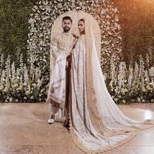 White Is The New Bridal Colour Deepika Padukone And Ranveer Singh Posing Together At Their Wedding Reception Were A S Bollywood Wedding Fashion Wedding Outfit