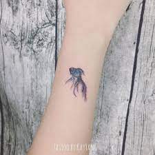 Pin By Caspian Woodward On Tattoos Goldfish Tattoo Elegant Tattoos Minimal Tattoo