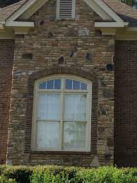 The roof is certainteed grand manor asphalt shingles designed to appear as slate. This Architectural Window Gets Extra Special Treament With Its Beautiful Brick Surrounding Trim Window Trim Exterior Exterior Brick Brick Window