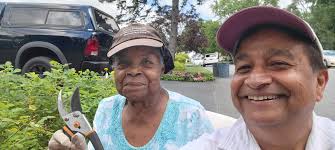 While walking in the area of Knob Hill Rd and Briarwood Rd of Town of  Colonie, I met Ms. Luretha Davenport while she was pruning rose bushes  outside of her house. She