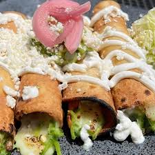 A delicious plate of fried rolled tortillas from Con Madre Kitchen Brodie.