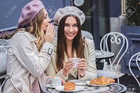 Like in this scene of beauty and the beast. Sharing Secrets With Best Friend High Angle View Of Beautiful Woman In Beret Whispering To Her Friend While Drinking Coffee In French Cafe Women Friends Gossiping During Coffee Time French Fashion Stock Photo