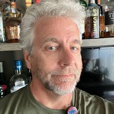 How to return a found photo of Johnny Gilbert to his family in Kenosha, WI?