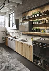 The space is decorated in industrial meets vintage style, and what i love most of all is the contrast between the whitewashed brick walls and black vintage wooden tableware and dishes stick to the style of the kitchen, and there are some plants and greenery that enliven it. Modern Loft Kitchen Design With A Vintage Industrial Look