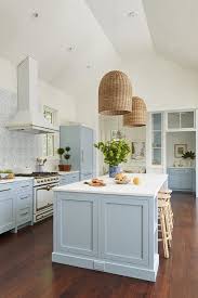 Peacock blue kitchen drawers are accented with brass hardware and a white quartz countertop mounted against white subway backsplash tiles. 25 Stylish And Inspiring Blue And White Kitchens Digsdigs
