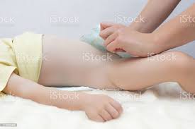 Girl Mother Puts A Diaper On To A Little Baby Caucasian Girl Dressing A Nappy To Her Daughter White Stock Photo Download Image Now Istock