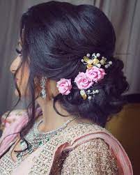 Slay The Hair On Your Engagement Pink Rose Lower Bun Loose Strands Hair Artistry By Archana Engagement Hairstyles Bridal Hair Buns Indian Bridal Hairstyles