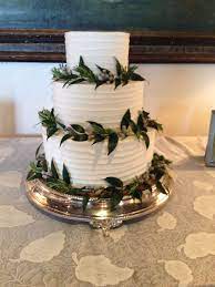 A Simple Wedding Cake Decorated With Silver Brunia Italian Ruscus And Rosemary To Beautifull Wedding Cake Decorations Tiered Wedding Cake Simple Wedding Cake